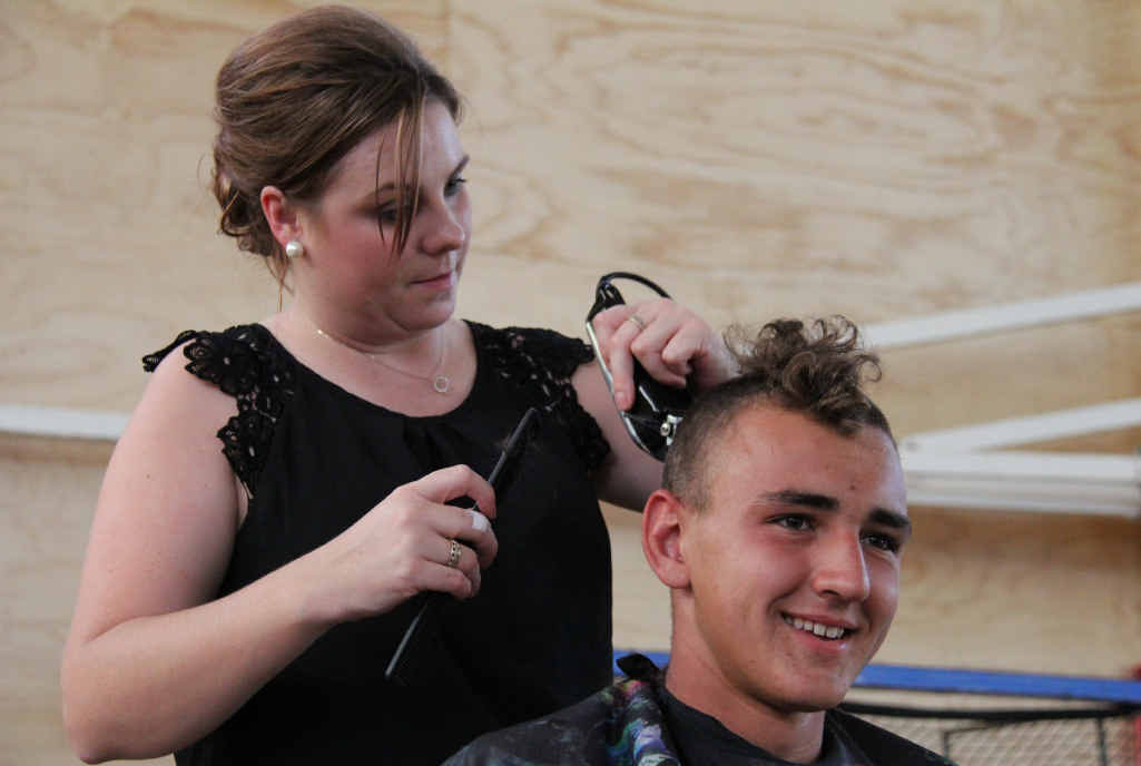 FOR A CAUSE: Talk’ N Heads hairdresser Kelsee Gillam cuts Brendan Hoffman’s hair as part of the World’s Greatest Shave event at Warwick State High School. FOR A CAUSE: Talk’ N Heads hairdresser Kelsee Gillam cuts Brendan Hoffman’s hair as part of the World’s Greatest Shave event at Warwick State High School.